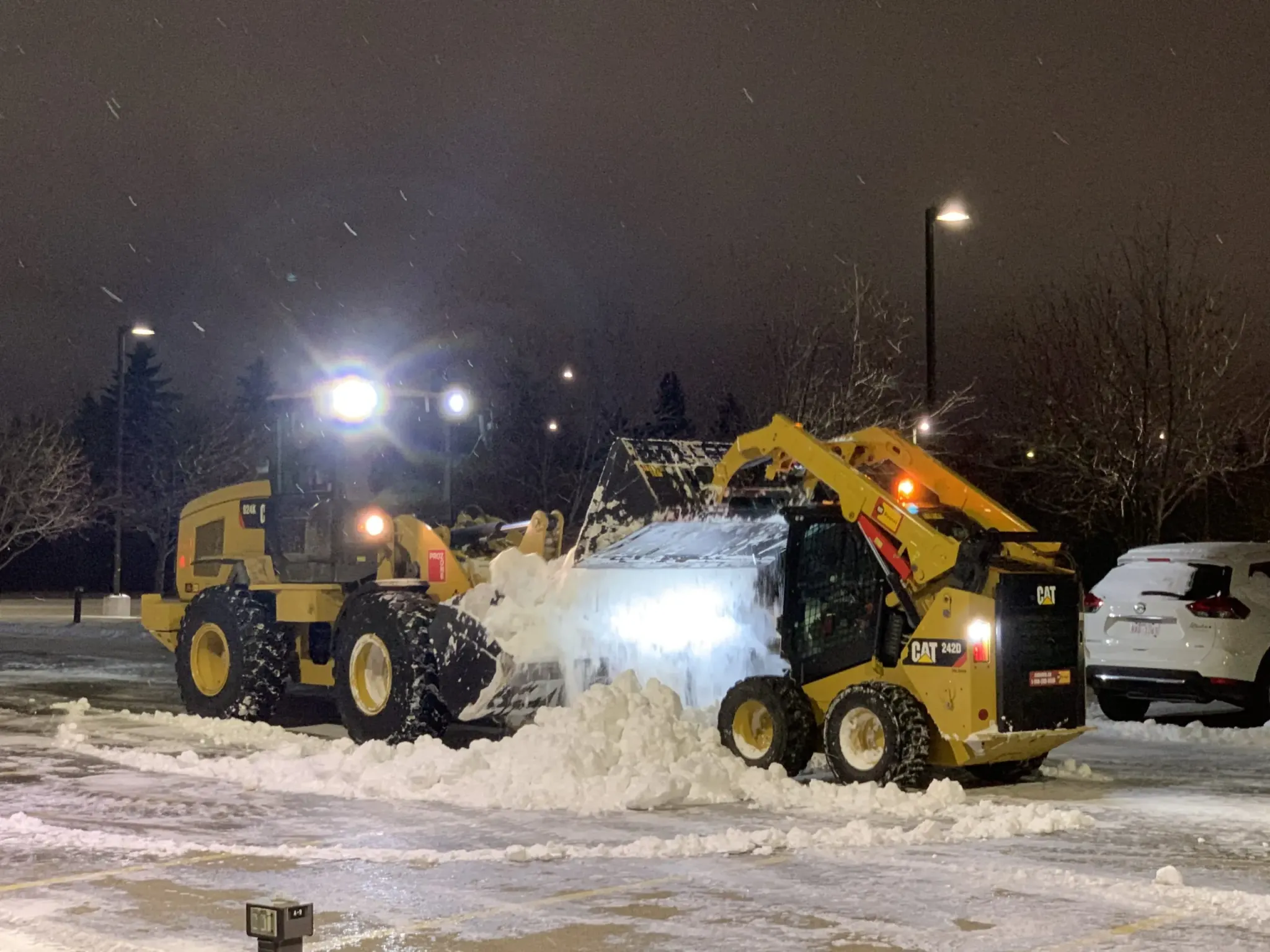 ELMS commercial snow removal equipment clearing snow with skid steers in Western North Carolina
